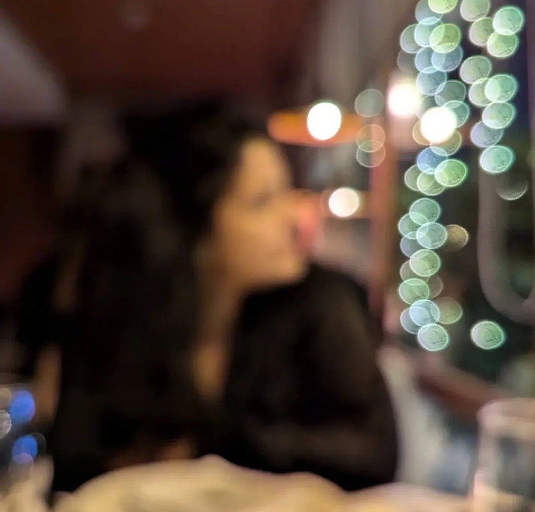Sara Noorani, photographed in soft focus against warm evening lights.